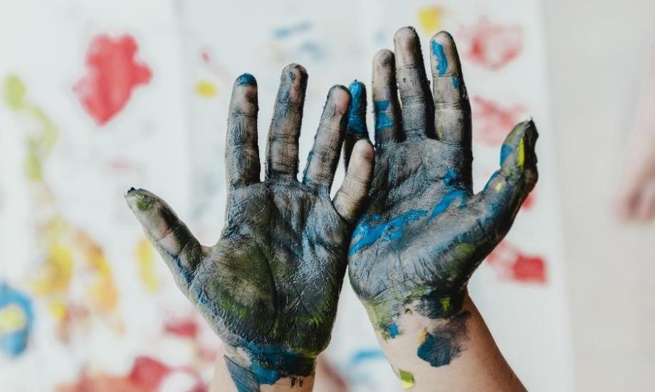 Two hands covered in blue paint