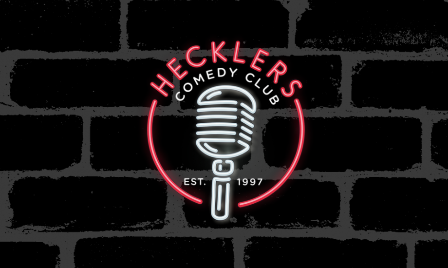 Hecklers Comedy Club LED logo on a black brick wall background.