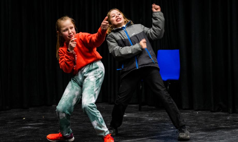 Image of two young people in the middle of performing